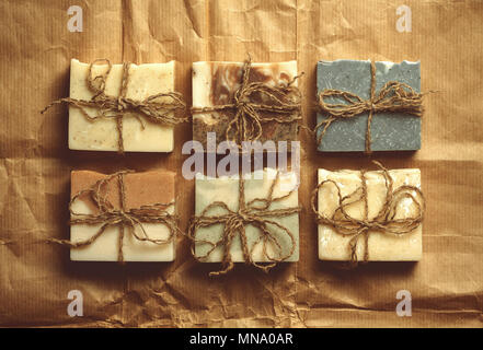 Organic handmade soap on crumpled packing paper. Stock Photo