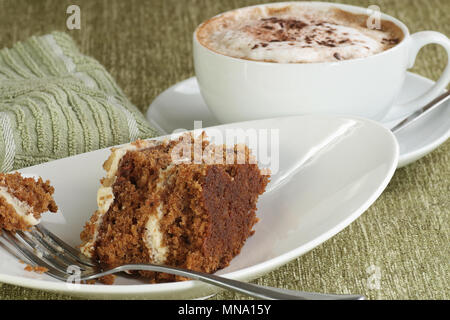 slice of home baked delicious carrot cake with a cup of coffee