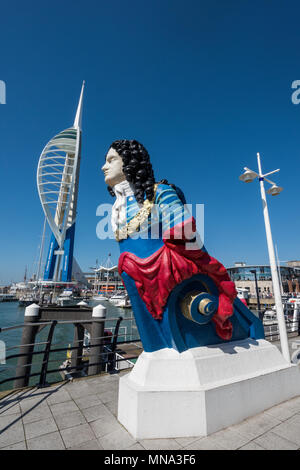 A ships figurehead and the spinnaker tower on the waterfront at Portsmouth harbour gunwharf quays shopping centre and restaurant retailers outlets.