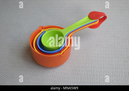 Nested Colorful rainbow kitchen measuring cups spoons colourful Stock Photo