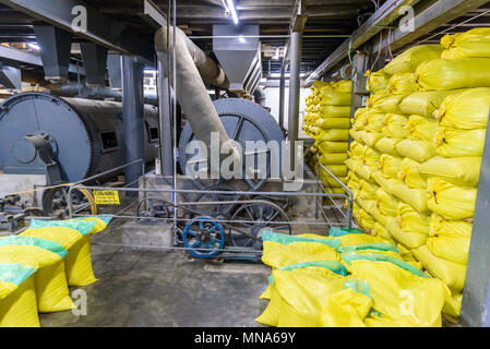 Coffee production. Coffee beans during the roasting process. Drum type roaster. Rosting process of coffee. Stock Photo