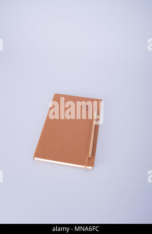 notebook or leather diary and pencil on the blackground Stock Photo