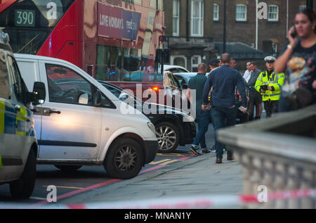 London, UK. 15th May 2018. According to reporters on the street, uncover police were going after a drug dealer who was in the Red Toyota Uber car but after the car was boxed in by unmarked police vehicles, he jumped out of the car and started running away from the scene.   Only for the BMW unmarked police car trying to block him from escaping, ended up running him over and knocking him down into the basement of residential apartments.15th May 2018.  Michael Tubi / Alamy Live News Stock Photo