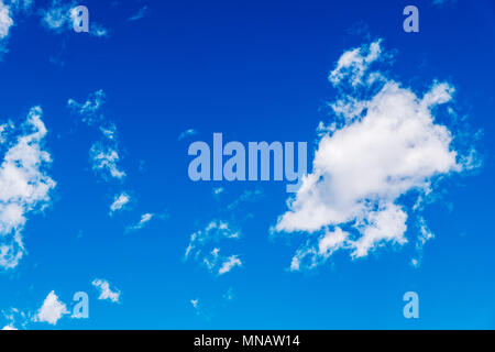 Puffy white clouds against a clear azure blue Colorado sky. Stock Photo