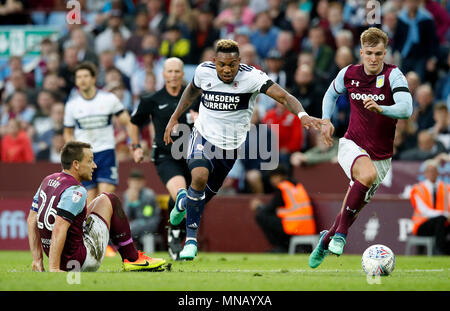 Middlesbrough's Britt Assombalonga (centre) gets away from Aston Villa's John Terry (left) and James Bree during the Sky Bet Championship Playoff match at Villa Park, Birmingham. Stock Photo