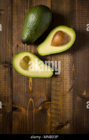 Avocado on Dark Wood Background. Healthy Food Concept. Stock Photo