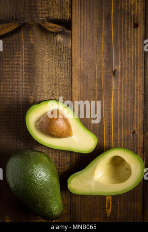 Avocado on Dark Wood Background. Healthy Food Concept. Stock Photo