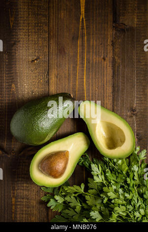 Avocado on Dark Wood Background. Healthy Food Concept. Stock Photo