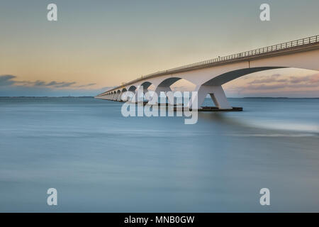 Long exposure photo of so-called Zeeland bridge at sunset, near Zierikzee in the Netherlands