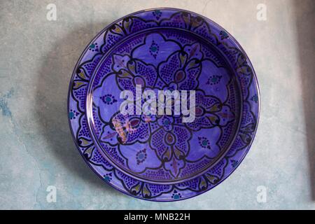 Purple decorative plate hanging on a wall in a home in Essaouira, Morocco Stock Photo