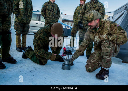 A United Kingdom Royal Marine briefs U.S. Marines with Marine Rotational Force 17.2 on how to properly utilize a lantern during exercise White Claymore in Bardufoss, Norway, Jan. 29, 2018. White Claymore is a joint bi-lateral arctic cold weather training package led by the United Kingdom Royal Marines to train and evaluate proficiency in cold weather operations and enhance strategic cooperation and partnership between the U.S. Marines and U.K. Royal Marines. (U.S. Marine Corps Stock Photo