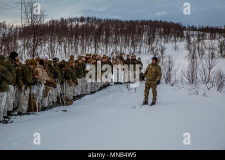 A United Kingdom Royal Marine briefs U.S. Marines with Marine Rotational Force 17.2 on the importance of sticking to the track plan during a movement during exercise White Claymore in Bardufoss, Norway, Feb. 6, 2018. White Claymore is a joint bi-lateral arctic cold weather training package led by the United Kingdom Royal Marines to train and evaluate proficiency in cold weather operations and enhance strategic cooperation and partnership between the U.S. Marines and U.K. Royal Marines. (U.S. Marine Corps Stock Photo