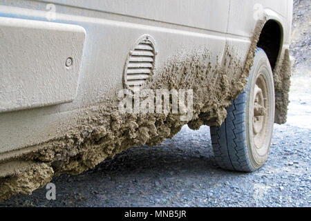 Very dirty muddy van after driving the endless Dalton Highway leading from Fairbanks to Prudhoe Bay, Alaska, USA Stock Photo