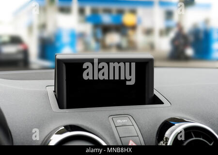 Car GPS on dashboard. Screen off. Selective focus. Stock Photo