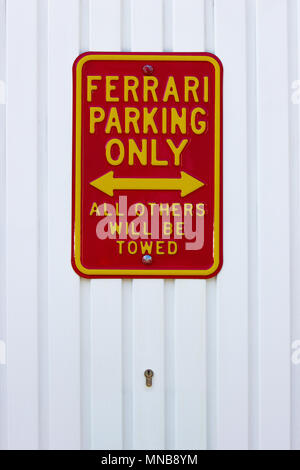 a beautiful funny red Ferrari notice on garage door, no parking sign Stock Photo