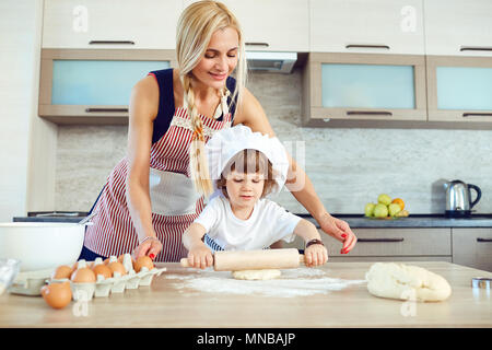 Mother and son bake cakes in the kitchen Stock Photo