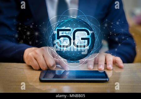 phone 5g Earth businessman connect worldwide waiter hand holding an empty digital tablet with smart and 5G network connection concept Stock Photo