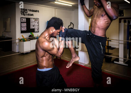 Agile fighter in defensive stance protecting his face from hit Stock Photo