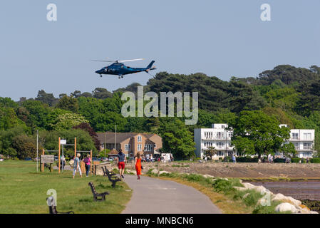 Helicopter taking off and departing after doing a pick up of passengers in Baiter Park, Poole, Dorset, UK Stock Photo