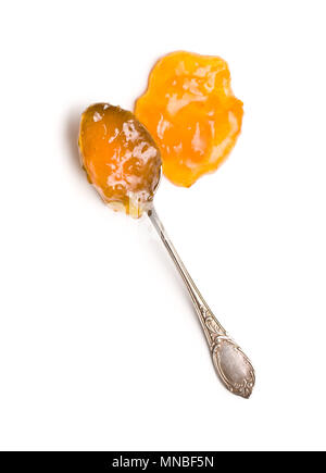 Tasty apricot jam in spoon isolated on white background. Top view. Stock Photo