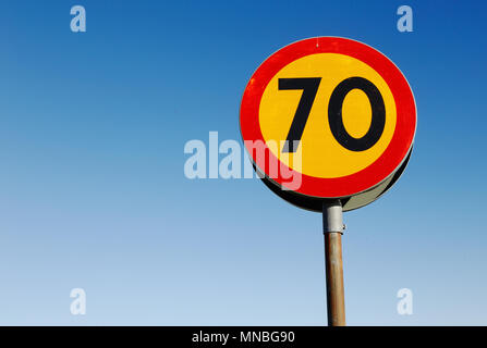 One speed linit sign 70 kmh against a blue sky. Stock Photo