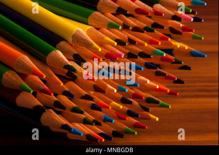Close-up of multicolored pencils with design elements in rows stacked on each other creating colorful patterns Stock Photo