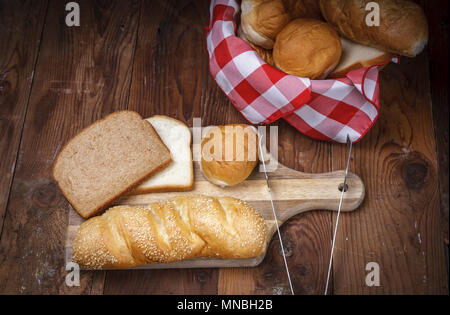 An overview of of various breads on a cutting board. Stock Photo