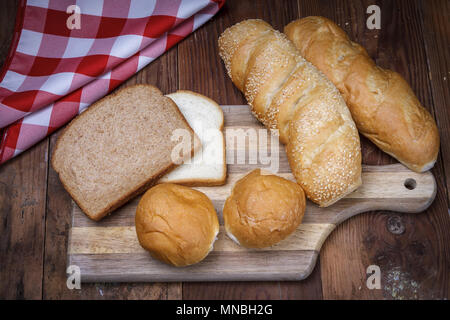 An overview of of various breads on a cutting board. Stock Photo