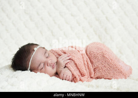 Cute newborn baby sleeping on soft white blanket background Stock Photo