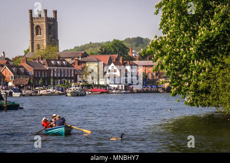 OXFORDSHIRE, UK - MAY 06, 2018: Family enjoying sunny day in boat at Henley on Thames. Henley is overlooked by a beautiful landscape of wooden hills. Stock Photo