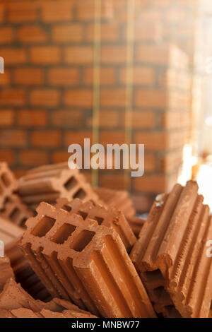 Close up of pile of red clay bricks in construction site Stock Photo