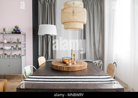 Interior with dining table, lamp and rack Stock Photo