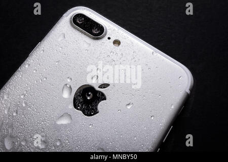 Krynica, Poland, May 02, 2018:  Close up of the Apple iPhone 7 Plus with water drops on a back side - smartphone water resistance test. Stock Photo