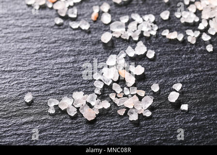 coarse grained salt crystals on black background - close up Stock Photo