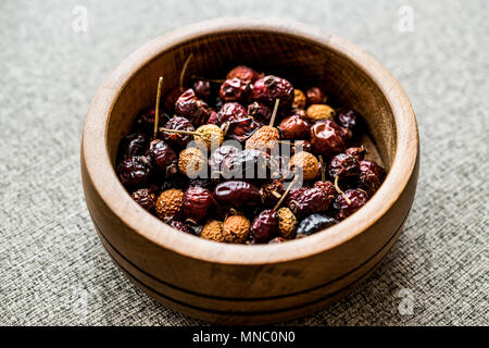 Dried Rosehips in wooden bowl. / kusburnu. Organic Concept. Stock Photo