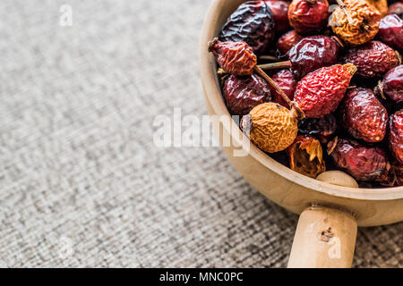 Dried Rosehips in wooden ladle / kusburnu. Organic Concept. Stock Photo