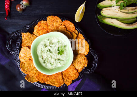 Tortilla chips with avocado dip served on a plate Stock Photo