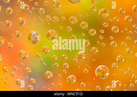 Colorful water drops on glass Stock Photo