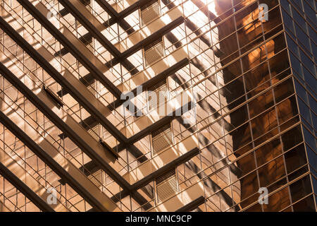 Abstract contemporary architecture fragment, walls made of gold toned glass with sun reflections Stock Photo