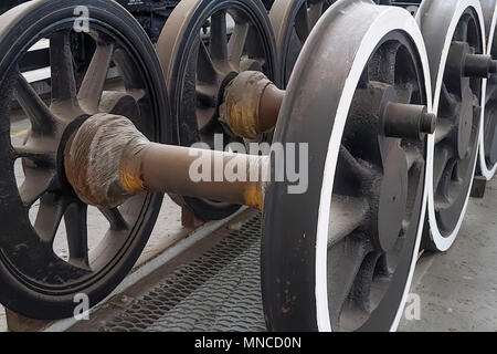 Steam train wheels waiting to be fitted during routine maintenance in a railway workshop. Stock Photo