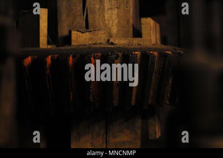 National Mills Weekend - Close up of watemill cog with orange flash. Stock Photo