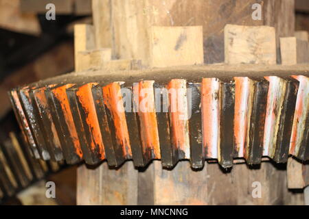 National Mills Weekend - Close up of watemill cog with orange flash. Stock Photo