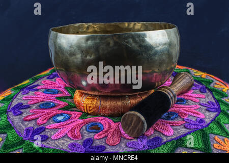 Tibetan handcrafted singing bowl on an Yoga Pillow Stock Photo
