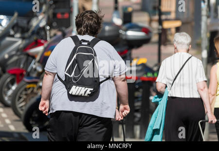 Obese man from behind walking away in the UK. Overweight concept. Stock Photo