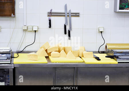 Pieces of cheese on a cutting table in the store Stock Photo