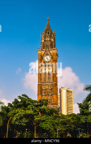 The Rajabai Clock Tower is a clock tower in South Mumbai India. It is near the Oval Maidan and Bombay High Court Stock Photo