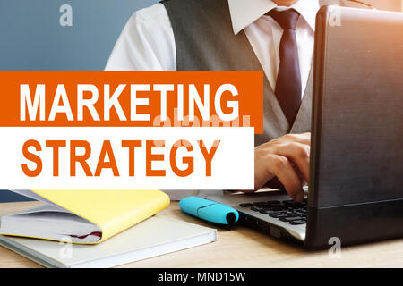 Marketing Strategy concept. Marketer working on a laptop. Stock Photo