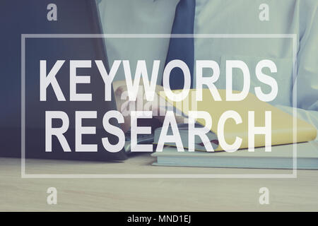 Keywords Research for SEO concept. Man is typing. Stock Photo