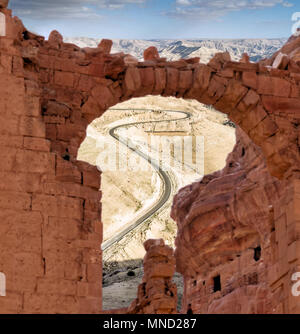 View through a ruin to a steep road with serpentines in the highlands of Jordan, composite photograph Stock Photo