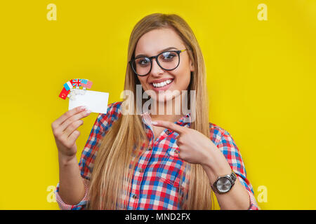 Young woman with card and flags of different speaking countries. Studio portrait of young beautiful female student Stock Photo